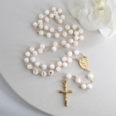 This Personalized Rosary, is ideal as a Baptism gift for a little girl or baby boy or as a gift for a special occasion. It is expertly handcrafted in a traditional style with a contemporary twist utilizing genuine Mother of pearl stone and gold-plated brass wire, which not only gives a touch of nature but also tenderness. The letter beads on the Rosary are also handmade from genuine mother of pearl, and the length is perfect to worn as a dainty Rosary necklace for women. *MATCHING ROSARY BRACELE Round Polished Bead Rosary As Gift, Polished Round Beads Rosary As Gift, Gift Rosary With 8mm Round Beads, 8mm Round Bead Rosary As Gift, Rosary With 8mm Round Beads As Gift, White Spiritual Cross Jewelry And Charms, Elegant Round Beads Rosary For First Communion, Pearl White Rosary With 8mm Beads As Gift, Adjustable Round Rosary As Gift