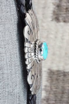 This turquoise and sterling silver bolo tie was made by Navajo silversmith Rosita Singer. The back is signed T&R Singer and stamped sterling.Tie Length: 22"Length: 2 3/8"Width: 1 3/4"Tips:Length: 2 1/8"Width: 1/4"Free shipping on all orders! We ship with USPS and always include tracking. All orders ship within a day of payment.Returns are accepted up to 30 days after you receive your order. Just send us a message. Our shop offers cash back or store credit. The item must be returned in new condit Western Silver Turquoise Necklace With Concho, Tie Length, Bolo Tie, Turquoise Sterling Silver, Turquoise Bracelet, Turquoise, Sterling Silver, Free Shipping, Silver