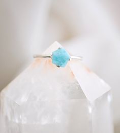 This petite yet dazzling ring, made of sterling silver, displays a beautiful slice of genuine Larimar. Regardless of your personal style, every gem boasts their own individual shape, making them just as exceptional as you. Each stone ranges in a mix of aqua blue and white. Larimar Meaning: Exclusive to the Dominican Republic, Larimar is a rare blue form of Pectolite. The man who coined the name Larimar, named it after his daughter, taking part of her name (Larissa) and the Spanish word for sea ( Light Blue Sterling Silver Jewelry With Accent Stones, Sterling Silver Turquoise Ring With Accent Stones As Gift, Healing Sterling Silver Turquoise Ring, Light Blue Sterling Silver Rings As Gifts, Light Blue Gemstone Jewelry In Sterling Silver, Larimar Turquoise Gemstone Ring For Anniversary, Light Blue Sterling Silver Gemstone Jewelry, Turquoise Moonstone Ring With Natural Stones As Gift, Minimalist Aquamarine Jewelry