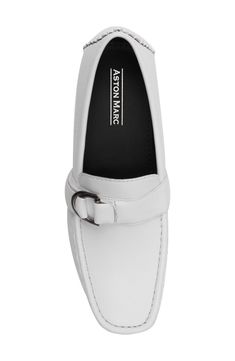 A silver-tone buckle details the vamp of this loafer crafted from textured faux leather. Moc toe Slip-on style Synthetic upper/rubber sole Imported Formal Flat Loafers With Buckle Closure, Classic Almond Toe Loafers With Buckle Closure, Classic Slip-on Loafers With Metal Pin Buckle, Business Loafers With Buckle Closure And Slip-on Design, Flat Loafers With Buckle Closure For Office, Formal Loafers With Buckle Closure, Casual Office Loafers With Buckle Closure, White Dress Shoes Men, White Dress Shoes