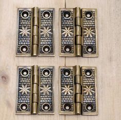 four antique brass plated hinges with flowers on them