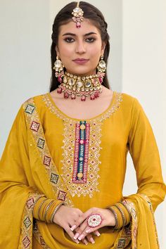 This Mustard color Party Wear Palazzo Salwar Suit flaunts sophistication with zari, resham, badla, and sequence work along the kameez. Accented by a baluming chinnon silk embroidered palazzo bottom, santoon lining, and sequence embroidered baluming chinon silk dupatta, this ensemble is perfect for weddings and other special events. Final sale Kameez baluming chinon silk with heavy embroidery & sequin work Sharara baluming chinon silk with heavy embroidery front and back Dupatta baluming chinon s Festive Slub Silk Sharara With Dabka Work, Festive Slub Silk Churidar With Resham Embroidery, Mirror Work Slub Silk Palazzo Set For Festivals, Designer Slub Silk Sets With Mirror Work, Mirror Work Slub Silk Sets, Slub Silk Palazzo Set With Mirror Work For Festivals, Gold Embroidered Slub Silk Sets, Bollywood Style Slub Silk Palazzo Set With Mirror Work, Festive Embroidered Slub Silk Palazzo Set