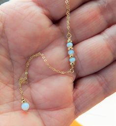 "OPAL LARIAT NECKLACE Our Opal Lariat Necklace features dainty white lab opals. Simple and elegant. Photos do not do this opal justice! IT'S IN THE DETAILS ✦ 14K Gold Filled, Sterling Silver or Rose Gold Filled Chain and all components ✦ White Lab Opals ( 3mm & 4mm) ✦ Shown at 17\" + 3\" Chain Drop To see ALL Lariat Necklaces, click here: https://www.etsy.com/shop/SimpleAndLayered?ref=seller-platform-mcnav&section_id=16420368 ✦ Handmade to order, please allow 3-5 days for us to make your October Birthstone Necklace, Best Friend Necklace, Jewelry Rose Gold, Gift Best Friend, Friend Necklaces, Necklace Gemstone, October Birthstone, Opal Necklace, Lariat Necklace