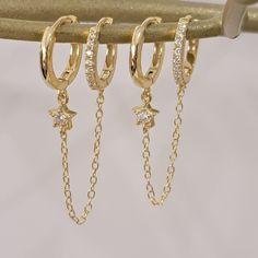 Minimalist Pave Duo Chain Earring, Star Chain Earrings, Chain Hoop Earrings, Gold Star Huggies Earrings, Star Crystal Drop Earrings, For Her ♥ DESCRIPTION:    ♥ This listing is just for 1 earring♥       Basic for this season! Elegant and delicate designer huggie hoops features tiny star and dainty drop chain.    Perfect for everyday wear or for a special occasion.    ♥ MATERIAL & SIZE:   Gold plated over Sterling Silver 10mm hoops, chain and dangle charm.     ♥ PROCESSING TIME:    Our current pr Earring Star, Chain Hoop Earrings, Star Crystal, Earrings Chain, Chain Earring, Earrings Star, Star Chain, Tiny Star, Hoop Earrings Gold