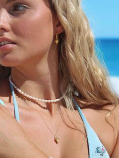 If you love shells as much as we do, this necklace is your pick. Our Conch Cove shell necklace is your new summer essential! Inspired by conch shells, our 18k gold & sterling silver beachy necklace can be worn on all your salty adventures. Made from water safe, non tarnish, high quality materials, you'll never have to worry about taking your jewelry off at the beach again. Adjustable chain - adjust this necklace to a length that suits you Made with sterling silver & 18k gold vermeil - will never Dainty Shell Charm Necklace For Beach, Dainty Shell Jewelry For Beach, Dainty Shell-shaped Summer Jewelry, Dainty Shell Necklace For Beach, Summer Beach Necklace With Pearl Pendant, Dainty Shell Necklace For Summer Beach, Dainty Pearl Charm Necklace For The Beach, Pearl Drop Shell Necklace For Beach, Summer Gold Pearl Necklace For Beach