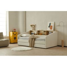 a child's daybed with storage drawers in a room