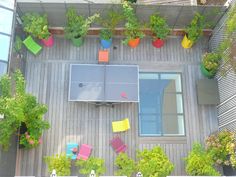 an overhead view of a table tennis court with colorful chairs and plants on the deck