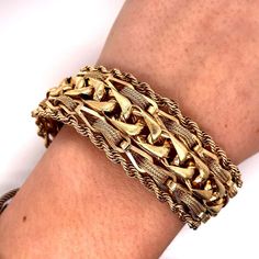 For Sale on 1stDibs - Vintage 1960s 14KY Gold Woven Wheat Link with Rope Edge Wide Charm Bracelet - The bracelet measure 7.15 inches long and 1 inch wide and features a hidden Vintage Yellow Gold Link Bracelets, Vintage Yellow Gold Link Bracelet, Antique Gold Bracelets With Box Clasp, Vintage Gold Bracelet As A Gift, Vintage 14k Gold Link Bracelet, Vintage Yellow Gold Bracelet With Box Clasp, Rectangular Gold Bracelet With 17 Jewels, Vintage Formal Chain Bracelet With Box Clasp, Gold Retro Collectible Bracelets