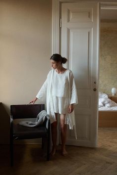 Linen robe designed for lounging routines. In full length, ¾ length dropped sleeves, and side seam pockets. Features a classic V-neck, and separate belt to delicately hug the body. This robe is crafted from natural and lightweight linen to ensure a breathable and soft experience. Cut in a relaxed shape, perfect to snuggle up with a morning coffee. SIZING AND FIT This garment is oversized. If you want to wear this piece as close-fitting, select a smaller size than you usually wear. Before placing Linen Robe, Pajama Robe, Womens Robes, Milky White, Wrinkle Remover, Style Expert, Hot Weather, Look Chic, White Linen