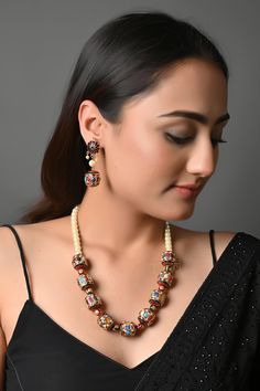 Pearls and Multicoloured Semi Precious Stones Jadau Meenakari Work Necklace With Earrings, Designer Indian Jewelry, Party Wear Necklace Multicolored Jadau stone work pearl necklace. This beautifully handcrafted necklace is set in copper alloy and plated with 22k gold. It will go with everything and make your outfit super chic. Perfect to wear to gala dinner, and perfect gift for family members, friends, or bridesmaids. PRODUCT DETAIL: * Necklace Length: 18 inches (comes with adjustable Lock) * Earrings Length: 1.5 inches approx * Material: Pearl, brass, and stone STYLE TIP: This necklace is a perfect accessory for Simple Indo western dresses or pastel ethnic attire. This necklace is a go-to accessory for chiffon sarees or georgette lehengas.  ABOUT US: Jaipri makes each piece of its produc Fusion Style Multicolor Jewelry Sets For Diwali, Fusion Multicolor Jewelry Sets For Diwali, Multicolor Beaded Temple Jewelry Earrings, Fusion Style Multicolor Jewelry Sets, Multicolor Meenakari Jewelry Gift, Elegant Multicolor Jewelry Sets For Diwali, Fusion Style Multicolor Temple Necklace For Festive Occasions, Multicolor Temple Jewelry For Celebration, Multicolor Fusion Bridal Necklace For Diwali