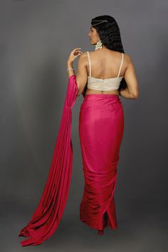 Engage your personality with the luxurious feel of this Satin One Minute Saree in Pink Red dual tone shades. Drape this specially for any festive, party, or wedding occasion.Product Features: Saree Color: Pink & Red Blouse Color: Gold Saree Fabric: Satin Blouse Fabric: Gold Art Silk (For beige metallic blouse choose the fabric option at check out) Work: Ombre Shoulder Drape: Customer must select the shoulder drape style while ordering Occasion: Party , Cocktail Party ,Wedding Reception, Bridesma Wedding Gown With Zari Work And Draped Shape, Draped Wedding Gown With Zari Work, Wedding Gown With Draped Zari Work, Traditional Pink Draped Lehenga, Traditional Draped Pink Lehenga, Fitted Draped Sharara With Pallu, Draped Gown With Zari Work For Party, Bollywood-style Draped Wedding Blouse Piece, Fitted Draped Wedding Lehenga