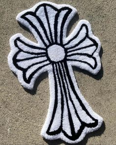 a white and black cross on the ground