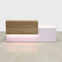 a white and wooden bench with light on it's sides in a room that has concrete flooring