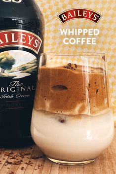 a bottle of bailey's whipped coffee next to a glass filled with ice cream