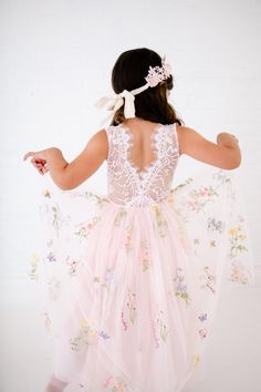 This stunning dress is a beautiful vintage inspired look...perfect for any little girl and occasion! This blush pink  dress has a boho flair and a super feminine feel with the soft vintage inspired lace. This tulle skirt is complete with embroidered florals and butterflies. The V back with unfinished lace and hem creates the perfect amount of bohemian vibes. Nicolette's Couture is a family owned boutique based out of Dubuque, Iowa.  When creating looks, comfort is our main priority...regardless of how chic a style is. We've had amazing success so far and believe our story is just beginning. The future looks bright for Nicolette's, and we're eager for you to hop on board and experience our brand's benefits.  Pair It With A Nicolette's Hairpiece:  https://www.etsy.com/shop/NicolettesCouture? Pink Fairy Dress For Summer Dress-up, Fitted Dresses With Floral Applique For Dress-up, Pink Fairy Dress For Summer Garden Party, Summer Floral Bridesmaid Dress, Princess Style Pink Floral Dress, Pink Princess Style Floral Dress, Pink Princess Dress With Floral Print, Fitted Princess Dress For Spring Wedding, Summer Princess Fairy Dress For Garden Party