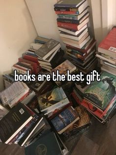 a pile of books sitting on top of a wooden floor