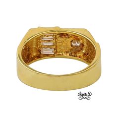 a gold ring with three stones on the front and side, set in 18k yellow gold