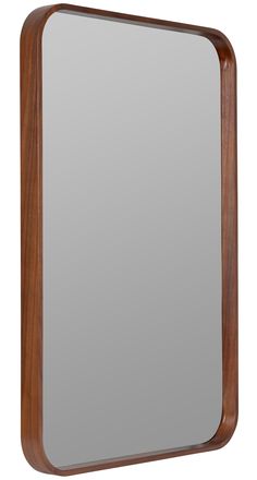 a wooden frame mirror sitting on top of a white wall