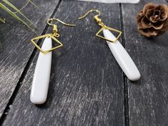 "These long white and gold drop earrings feature 39mm flat white acrylic teardrop beads, overlaid at the top with 12mm gold-plated brass open square links. These lightweight earrings transition effortlessly from office wear to street wear, and are lightweight enough to wear all day. These white drop earrings measure 2.5 inches from the bottom of the teardrop to the top of the ear wires, which are made of hypoallergenic gold-plated surgical steel. Domestic shipping is always free here at MayaMade White Long Drop Earrings For Gift, Modern White Earrings With Ear Wire, White Drop Earrings For Pierced Ears, White Teardrop Earrings As Gift, White Pearl Drop Teardrop Earrings, White Drop Earrings For Gift, White Drop Earrings Gift, Modern White Drop Earrings, White Long Drop Ear Wire Jewelry