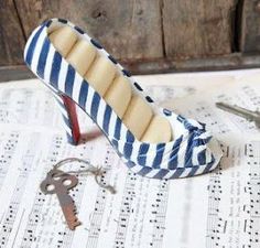 a pair of shoes sitting on top of sheet music next to a pair of keys