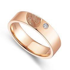 a rose gold ring with a fingerprint on the front and diamond in the center