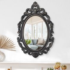 a living room filled with furniture and a round mirror