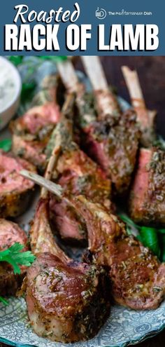 roasted rack of lamb on a plate with green peppers and parsley garnish