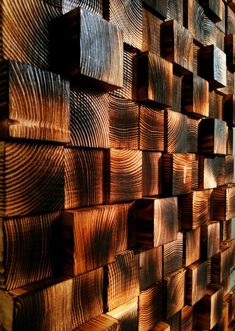 the wood has been cut into squares and arranged on top of each other in order to create an interesting wall decoration