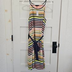 Colorful Striped Dress With Navy Blue Ribbon To Tie Striped Summer Dress With Tie Waist, Summer Striped Dress With Tie Waist, Striped Tie Waist Dress For Day Out, Striped Spring Dresses With Tie Waist, Spring Striped Dress With Tie Waist, Striped Dresses With Tie Waist For Spring, Striped Dress With Tie Waist For Spring, Striped Sleeveless Dress For Brunch, Sleeveless Striped Dress For Brunch