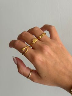 Gold coiled snake ring is adorable and edgy, and a very trendy look for jewelry. Cute serpent snake ring that non-tarnishing - stainless steel and gold - non-tarnishing Socials: Insta: @vasi.jewelry  Site: http://vasijewelry.com Tik Tok: vasi.jewelry Care - protect your jewelry from things that could scratch the surface - keep away from harsh chemicals - store jewelry away from the sun and in a microfiber pouch - clean your pieces with warm water and detergent-free soap and thoroughly dry - poli Gold Minimalist Snake Ring For Promise, Gold Minimalist Snake Ring As Promise Ring, Handmade Gold Snake Ring, Gold Minimalist Snake Ring For Gift, Gold Minimalist Snake Ring, Minimalist Snake Ring As A Gift, Rings Simple Everyday, Chicago Beats, Dainty Ring Stack