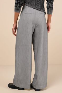 Banish the workweek blues when you style your office-approved look with the Lulus Composed Moment Grey High-Rise Wide-Leg Trouser Pants! Lightly stretchy woven fabric (with a slight tonal effect) shapes a high waist, belt loops, and a hidden zip fly with a top button closure. Chic pleating accents the wide-leg silhouette, which has functional front diagonal pockets and decorative welt pockets at the back. Ankle-length hems complete the look. Fit: This garment fits true to size. Length: Floor len Elegant Gray Wide Leg Workwear Pants, Elegant Gray Wide Leg Pants For Work, Non-stretch Gray Pants For Workwear, Non-stretch Wide Leg Work Pants For Business Casual, Versatile Bottoms With Elastic Waistband For Work, Office Chic Formal Bottoms For Spring, Versatile Spring Office Dress Pants, Versatile Formal Dress Pants For Spring, Spring Formal Office Chic Bottoms