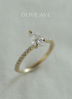 an engagement ring with a pear shaped diamond