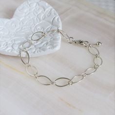 "* Sterling Silver Long Loop Layering Bracelet * * Beautiful sterling silver long loop layering bracelet finished with a sterling silver lobster claw clasp and completed with sterling silver bead. This bracelet 7\" long and is created with 925 sterling silver material and not made with plated materials. * Heart Clay Dish (also sold separately) https://www.etsy.com/listing/1094093610/heart-ring-dish-boho-ring-dish-christmas * This bracelet will arrive in a box tied with a ribbon perfect for gift Simple Handmade Silver Bracelets, Simple Handmade Silver Bracelet, Adjustable Oval Link Sterling Silver Bracelet As Gift, Nickel-free Link Chain Bracelet Minimalist Style, Dainty Handmade Silver Chain Bracelet, Minimalist Oval Chain Bracelet Gift, Elegant Handmade Sterling Silver Bracelet For Everyday, Elegant Hypoallergenic Sterling Silver Chain Bracelet, Adjustable Sterling Silver Charm Bracelet Modern Style