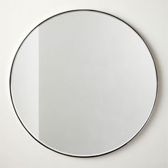 a round mirror hanging on the wall