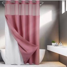 a pink and white shower curtain in a bathroom