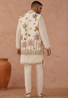 Step into sophistication with Off White Jacket Kurta Set. Crafted from luxurious georgette, the jacket showcases exquisite resham and sequinned embroidery work, while the yoke design kurta features stunning all-over motifs and meticulous detailing. Completed with a beautifully embroidered dupatta and matching pants. Perfect for Sangeet, Mehendi, Haldi, or as a wedding guest outfit. Composition : Jacket, Kurta, Trouser & Dupatta : Viscose Georgette Care: Dry Clean Only and Vacuum Storage This pro Bollywood Style Outerwear With Chikankari Embroidery, Spring Bandhgala With Floral Embroidery In Chanderi, Unstitched Chikankari Embroidery Nehru Jacket For Spring, Eid Outerwear Straight Kurta With Resham Embroidery, Unstitched Nehru Jacket With Resham Embroidery For Spring, Spring Bollywood Nehru Jacket With Intricate Embroidery, Spring Embroidered Chanderi Sherwani, Spring Designer Embroidered Sherwani, Designer Chanderi Outerwear With Resham Embroidery