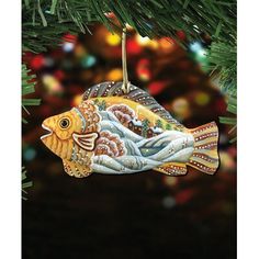 a fish ornament hanging from a christmas tree