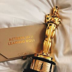 the oscar statue is next to an award for leading role in the film's production