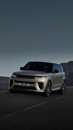 the new range rover is shown in front of mountains