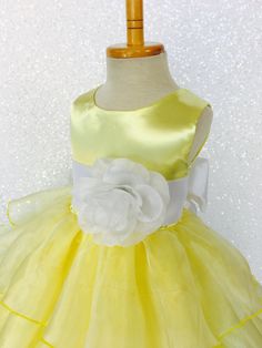 Beautiful organza ruffled dress tailor-made and ready to impress at any upscale event! Handcrafted with the upmost of care and attention to detail, we make sure that each dress is perfectly one of a kind for your little girl. Bridal satin top followed by a satin sash for a nice and snug fit Comes with a flower and matching colored sash. The skirt has layers of cut organza strips which are sewn onto the lining to create the ruffled effect The organza is then sewn at the edges to create those cris Formal Organza Dress With Bow, Yellow Princess Wedding Gown, Organza Dress With Bow For Dress-up Occasions, Elegant Yellow Princess Dress For Wedding, Yellow Ruffled Wedding Dress, Yellow Wedding Gown With Ruffles, Fitted Tulle Dress With Sashes, Sleeveless Tulle Dress With Satin Bow, Elegant Yellow Tulle Princess Dress