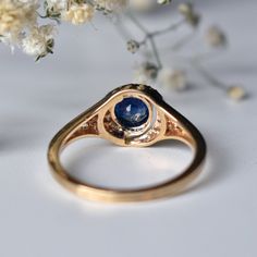 "A real stunner, this 0.77 ct natural Blue Sapphire & diamond ring features a bezel set round Blue Sapphire in solid 14K Yellow Gold, with double crescent shaped diamond half halos, forming a unique pattern. Your perfect something blue, this one of a kind ring will definitely set you apart! * Center Stone : Natural Sapphire * Stone Weight : 0.77 cts * Shape : Round * Diamond Wt. : 0.10 Cts * Diamond Color- Purity : H-I VS SI * Gold - 14kt, 2.9 gms solid yellow gold (approx) If you like this Elegant Sapphire Ring With Bezel Setting, Elegant Round Sapphire Ring With Bezel Setting, Round Sapphire Ring With Bezel Setting, Sapphire Birthstone Ring With Bezel Setting, Sapphire Promise Ring With Bezel Setting And Round Stone, Classic Sapphire Diamond Ring With Bezel Setting, Fine Jewelry Round Halo Ring With Bezel Setting, Elegant Sapphire Birthstone Ring With Bezel Setting, Round Halo Ring With Bezel Setting