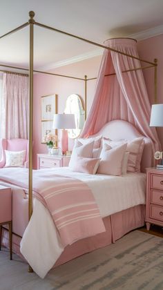 a pink and gold bedroom with four poster bed