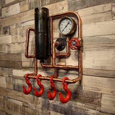 a wall with pipes and gauges mounted to it's side on a wood paneled wall