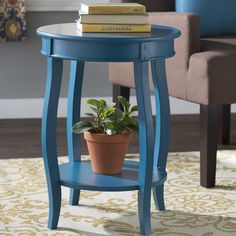 a small blue table with a potted plant on it