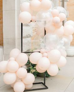 a bunch of balloons that are in front of a mirror