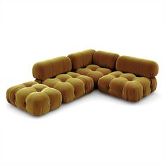 a large sectional couch with multiple pillows on it's back and side ends, facing the viewer