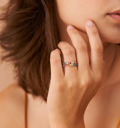 Meet our Mini Rainbow Band Ring- this whimsical piece is adorned with an arc of meticulously selected CZ stones, each shimmering with the joyous hues of the rainbow. Perfect for the color-loving daydreamer, this ring is more than an accessory—it's your very own piece of wearable joy. Stackable Multicolor Jewelry, Adjustable Rainbow Gemstone Ring, Rainbow Birthstone Rings Fine Jewelry, Rainbow Birthstone Rings In Fine Jewelry, Adjustable Multicolor Stackable Rings, Rainbow Stackable Cubic Zirconia Rings, Rainbow Cubic Zirconia Stackable Rings, Rainbow Stackable Rings In Cubic Zirconia, Everyday Rainbow Round Jewelry