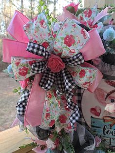 a pink and black bow with flowers on it next to a sign that says country girl