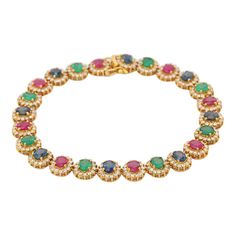 Emerald, Ruby, Blue Sapphire and Diamond bracelet in 18K Gold. It has a perfect oval cut gemstone to make you stand out on any occasion or an event. A tennis bracelet is an essential piece of jewelry when it comes to your wedding day. The sleek and elegant style complements the attire beautifully, whether it's the bride wearing it herself, or as a gift to her bridesmaids to wear on the D’day.  Bracelets are worn to enhance the look. Women love to look good. It is common to see a woman rocking a Elegant Multi-stone Oval Tennis Bracelet, Elegant Oval Multi-stone Tennis Bracelet, Formal Multi-stone Cubic Zirconia Tennis Bracelet, Luxury Oval Multi-stone Tennis Bracelet, Elegant Multi-stone Diamond Bracelet, Oval Multi-stone Tennis Bracelet In Fine Jewelry Style, Oval Gemstone Tennis Bracelet For Wedding, Elegant Multi-stone Round Tennis Bracelet, Classic Oval Multi-stone Bracelet