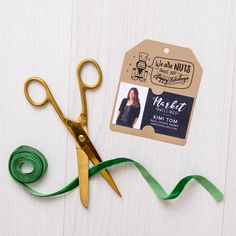 a pair of gold scissors sitting next to a green ribbon and tag that says happy fall y'all